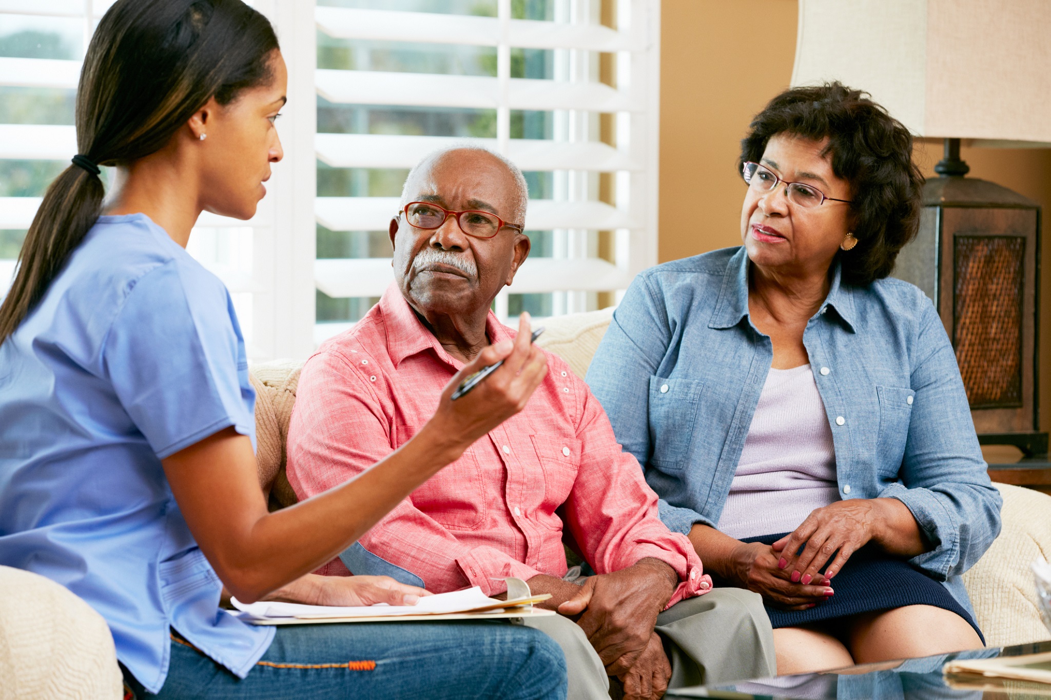 Care home member of staff talking to a resident
